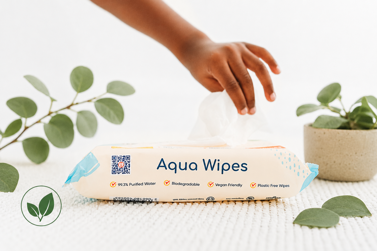 Hand taking a wipe from a pack of Aqua Wipes plastic-free baby wipes
